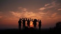 Silhouette of group happy business team making high hands over head in beautiful sunset sky evening time Royalty Free Stock Photo