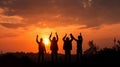 Silhouette of group happy business team making high hands over head in beautiful sunset sky evening time Royalty Free Stock Photo