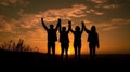 Silhouette of group happy business team making high hands over head in beautiful sunset sky evening time Royalty Free Stock Photo