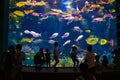 Silhouette group of people with family in front of aquarium tank