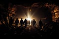 Silhouette of a group of people walking in the mine at night, Silhouette of miners with headlamps entering an underground coal