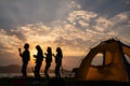 Silhouette Group of teenage asian girl dancing and party with drink bottles happy enjoy travel camping beside the lake at sunset Royalty Free Stock Photo