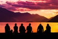 Silhouette Group of Young People Sitting on Beach