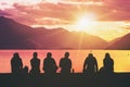 Silhouette Group of Young People Sitting on Beach