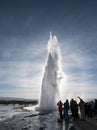 Silhouette, groups of tourist watching natural hot spring geyser erupting in Strokkur, Iceland