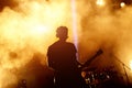 Silhouette of guitar player in action on stage Royalty Free Stock Photo