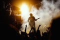 Silhouette of guitar player, guitarist perform on concert stage. Dark background, smoke, concert spotlights Royalty Free Stock Photo