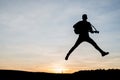 Silhouette of guitar player jump on stone Royalty Free Stock Photo