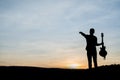 Silhouette of guitar player jump on stone Royalty Free Stock Photo