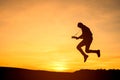 Silhouette of guitar player jump on stone Royalty Free Stock Photo