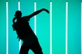 Silhouette of guy breakdancer in cap dance hip-hop in neon blue light. Dance school poster. Close up. Royalty Free Stock Photo