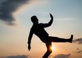 silhouette of guy making step in sense of freedom on sunrise sky, future