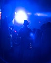 Silhouette of a guy wearing headphones at Vienna festival in silent disco with blue light, Austria