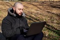 Guy working on a laptop in the park Royalty Free Stock Photo