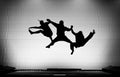 Silhouette of gymnasts on trampoline Royalty Free Stock Photo