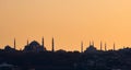 Silhouette of Hagia Sophia and the Blue Mosque of Sultanahmet, in Istambul, Turkey, against the ochre afternoon sky. Royalty Free Stock Photo
