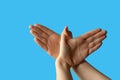 Silhouette of a hand gesture similar to a bird flying on a blue background Royalty Free Stock Photo