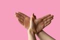 Silhouette of a hand gesture similar to a bird flying on a pink background Royalty Free Stock Photo