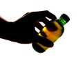 Silhouette of hand holding bottle of larger Royalty Free Stock Photo