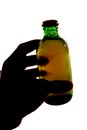 Silhouette of hand holding bottle of larger Royalty Free Stock Photo