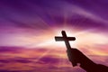 Silhouette of hand holding christian cross Royalty Free Stock Photo