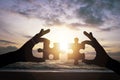 Silhouette hand holding and connect jigsaw puzzle on the beach and sunset background. It is symbol of business corporate teamwork