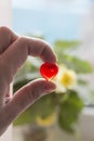 Silhouette hand holding plastic heart with blurred background Royalty Free Stock Photo