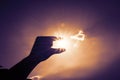 Silhouette of Hand picking sun at blue sky and cloud,Vintage filter Royalty Free Stock Photo