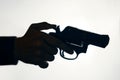 Silhouette of man& x27;s hand with revolver on white background. Royalty Free Stock Photo