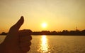 Silhouette of a hand with thumb up on rising sun background Royalty Free Stock Photo