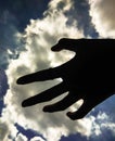 Silhouette hand under the sky background Royalty Free Stock Photo