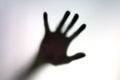 Silhouette of hand on a white surface