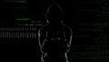 Silhouette of handcuffed angry hacker on animated computer code background