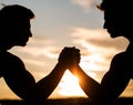 Silhouette of hands that compete in strength. Rivalry, closeup of male arm wrestling. Men measuring forces, arms. Two Royalty Free Stock Photo