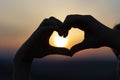 Silhouette of hands forming a heart on a sunset sky background Royalty Free Stock Photo