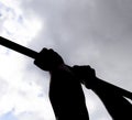 Silhouette of hands on a horizontal bar. Hands on the bar close-up. The man pulls himself up on the bar. Playing sports in the fre Royalty Free Stock Photo