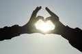 Silhouette of hands making heart with sun inside, close-up Royalty Free Stock Photo