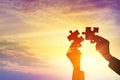 Silhouette of hands woman holding a jigsaw puzzle piece at sunsetsky Royalty Free Stock Photo