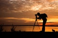 Silhouette Handsome Photographer take a photo with professional camera Royalty Free Stock Photo