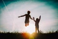 Silhouette of happy boy and girl enjoy sunset nature Royalty Free Stock Photo