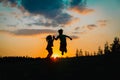 Silhouette of happy boy and girl enjoy sunset nature Royalty Free Stock Photo