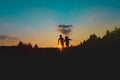 Silhouette of happy boy and girl play at sunset Royalty Free Stock Photo