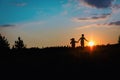 Silhouette of happy boy and girl run at sunset Royalty Free Stock Photo