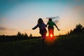 Silhouette of happy boy and girl running play at sunset Royalty Free Stock Photo