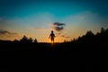 Silhouette of happy boy run and play at sunset