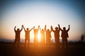 Silhouette of happy business human team making high hands over head in sunset sky evening time background for business teamwork Royalty Free Stock Photo