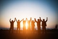 Silhouette of happy business human team making high hands over head in sunset sky evening time background for business teamwork