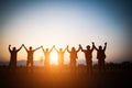 Silhouette of happy business human team making high hands over head in sunset sky evening time background for business teamwork