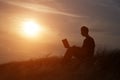 Silhouette of happy business man with laptop working on the field Royalty Free Stock Photo