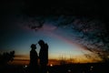 Silhouette of happy couple looking at each other and touching wi Royalty Free Stock Photo